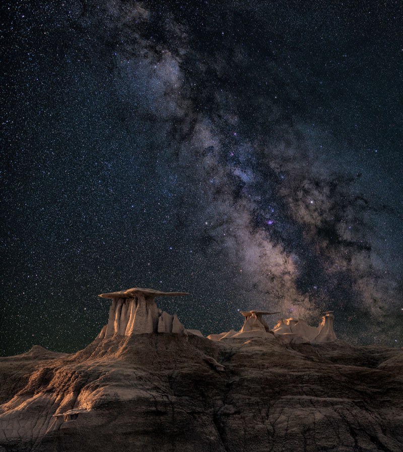 the milky way rises above the rock formations against the star studded night sky, _wayfinders 4k