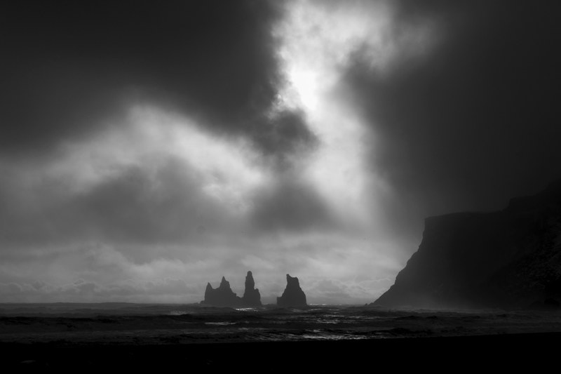 dark sky over rock formations in a stormy sea, vk in the winter 4k