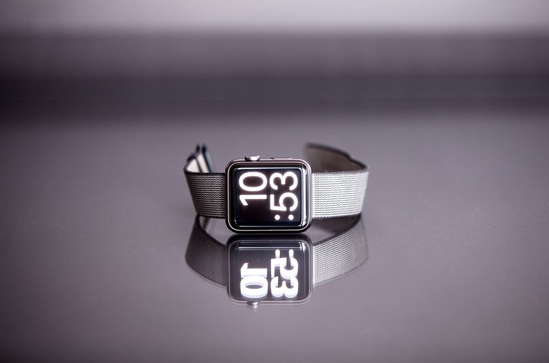 apple wrist watch on its side reads 1053 as it sits on a flat surface, apple watch on side 4k