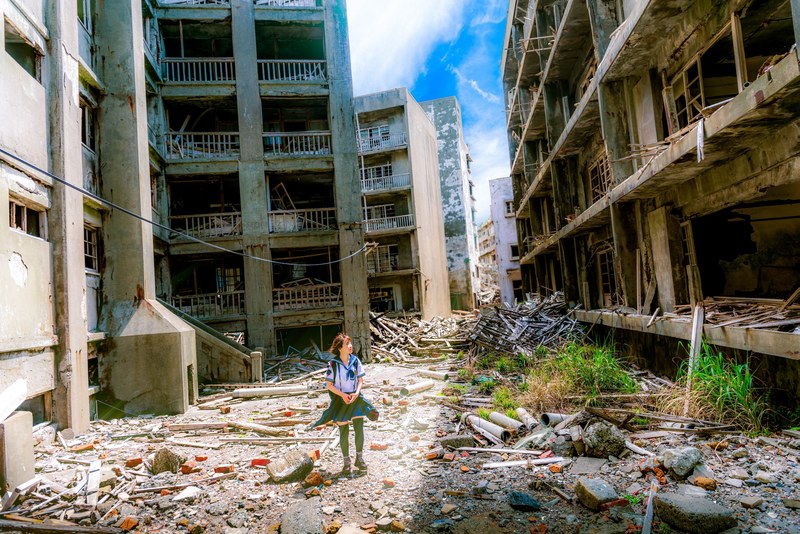 a woman wearing a skirt walking through the war torn city of gunkanjima, the lost student of gunkanjima 4k