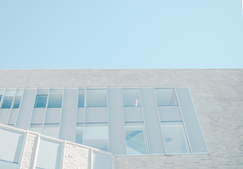 a stairwell in a building seen through its windows, stairwell behind tall windows 4k