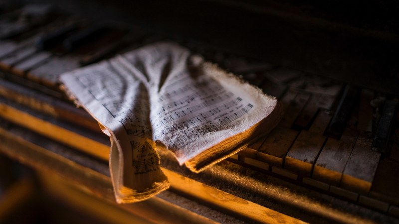 an torn up music score on an old piano, lost notes 4k