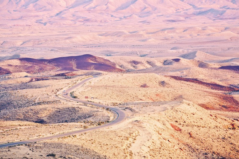 winding road curves through the dry desert dunes of yeruham, driving in the desert 4k