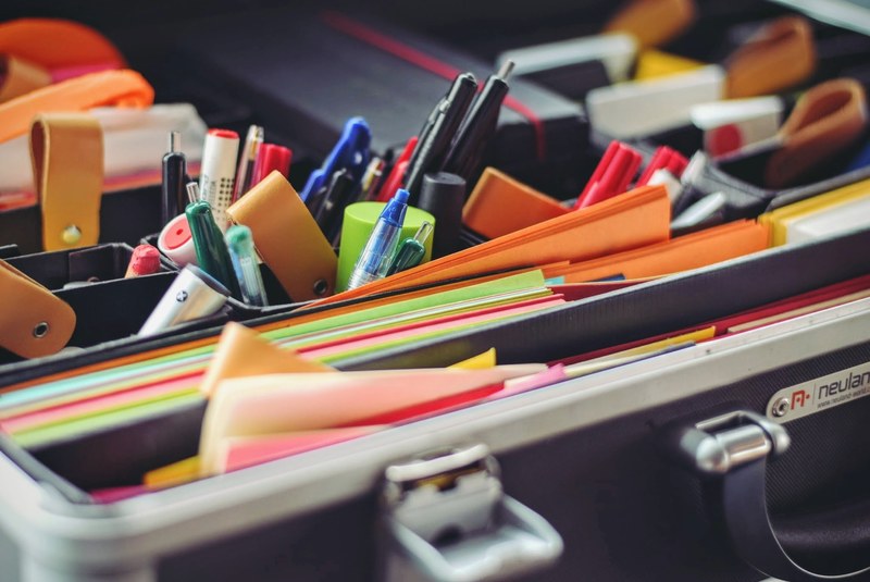 office supplies neatly organized in several compartments, office organizer close up 4k