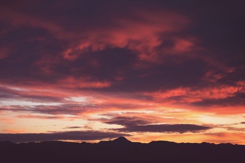 pink and orange cloudy sky at sunset or sunrise overlooking a silhouette mountain range in vandenberg village, sunset 4k
