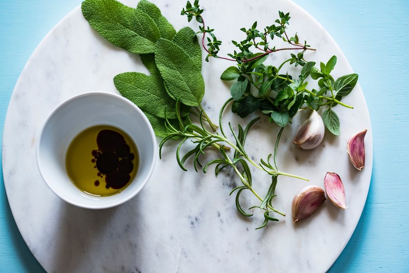 flat lay of ingredients including olive oil herbs and garlic cloves, italian ingredients 4k