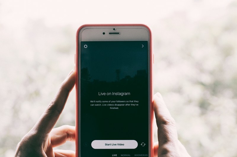 a person holding an iphone with instagram live videos open, live on instagram 4k