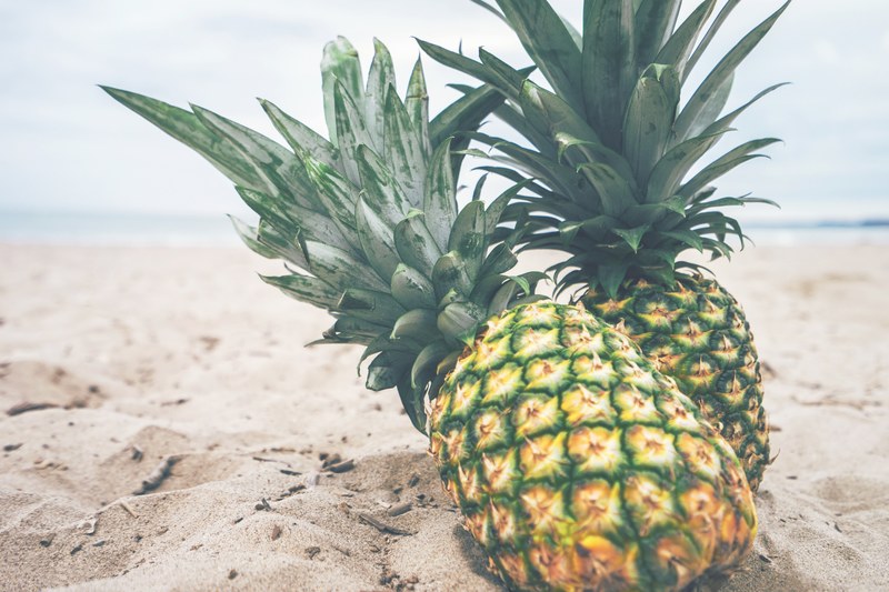two pineapples on a tropical beach, two pineapples 4k