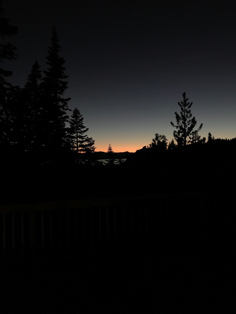 a silhouette of a treeline against a twilight sky, tahoe sunset 4k