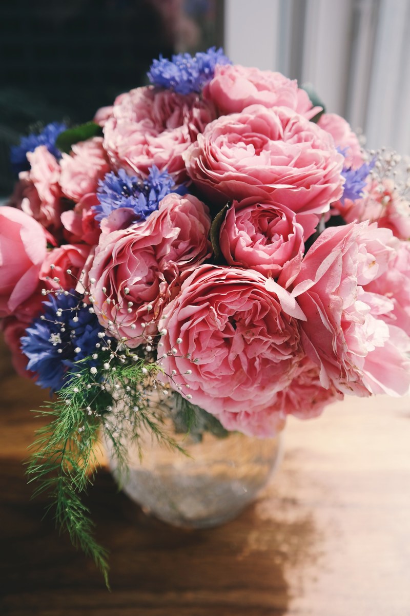 a vase with large pink peony flowers and smaller white and violet flowers, sensational flower vase 4k