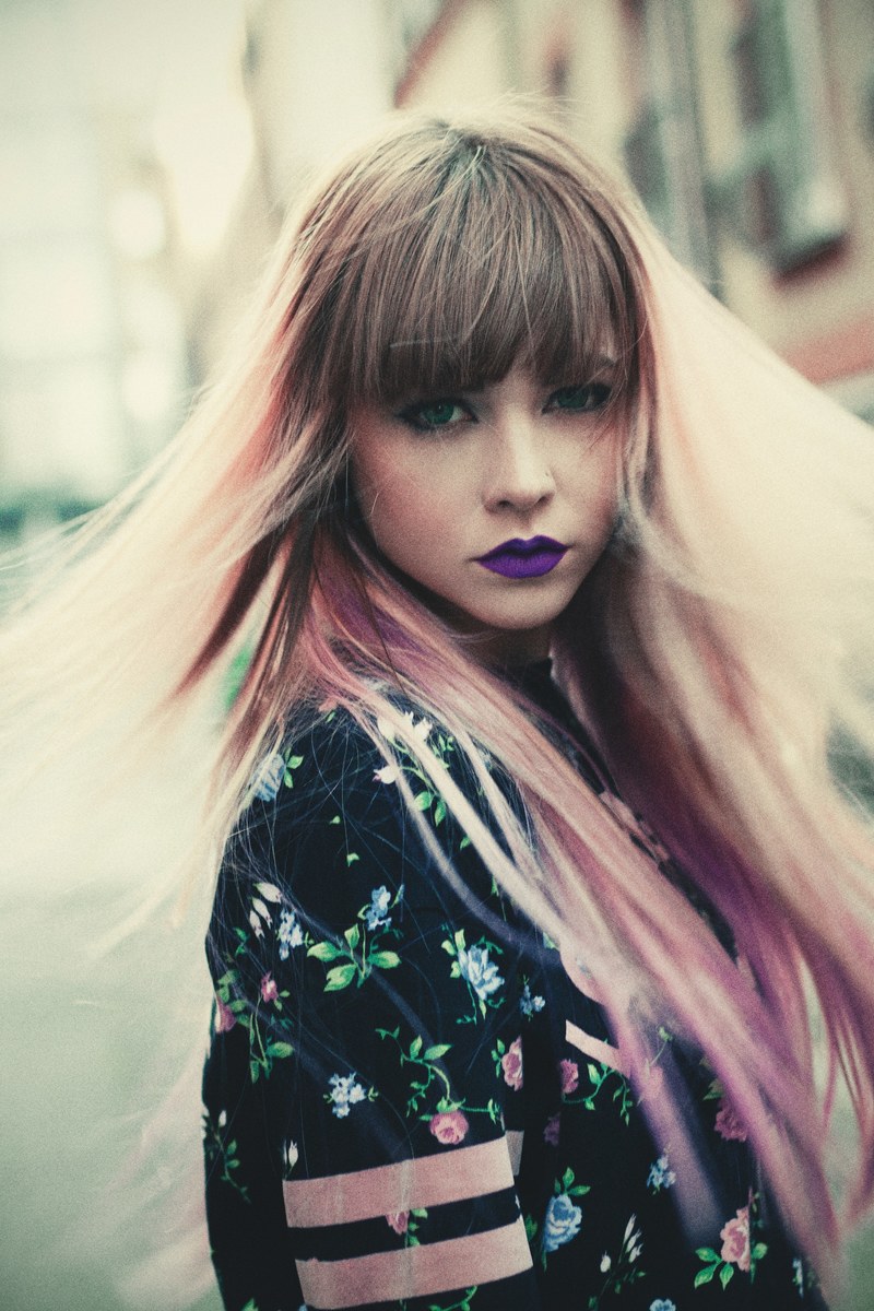 woman with bold purple lipstick shakes out her hair, colorful lips and hair 4k