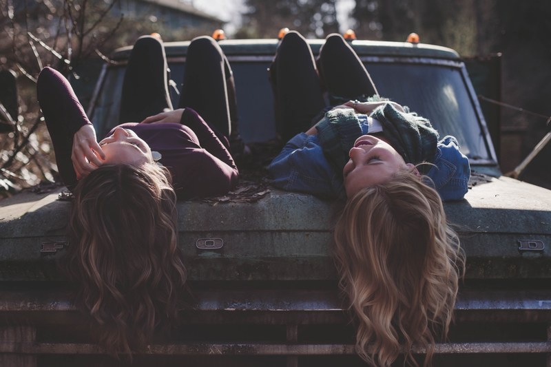 teens girls lying on the hood of the old truck, _girls on old truck 4k