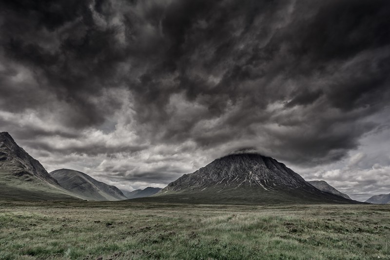 dark storm clouds above the valley with small rocky hills at glencoe, dark clouds above the hilly valley 4k