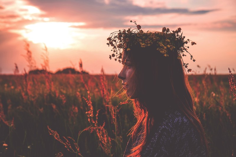 young bohemian girl with flower crown poses in meadow with light from sunrise at suchawa, girl with flower crown in suchawa field 4k