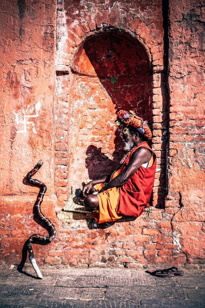 a brick arch where an old man sits to carve while crossing his legs, _yogi meditating 4k