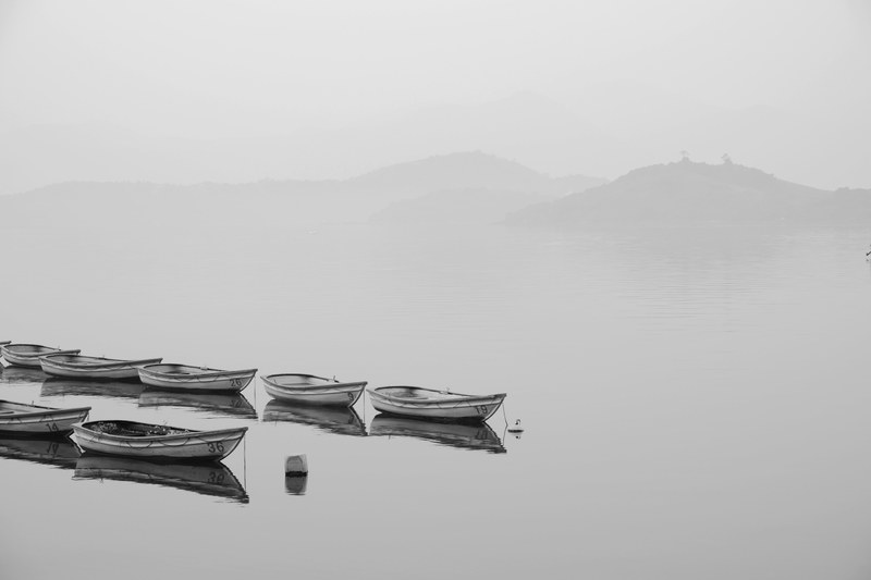 dreamy monochrome shot of boats in a placid latke, _placid lake boats 4k