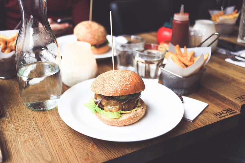 plates of cheeseburgers and fries at an american restaurant, burgers and fries 4k