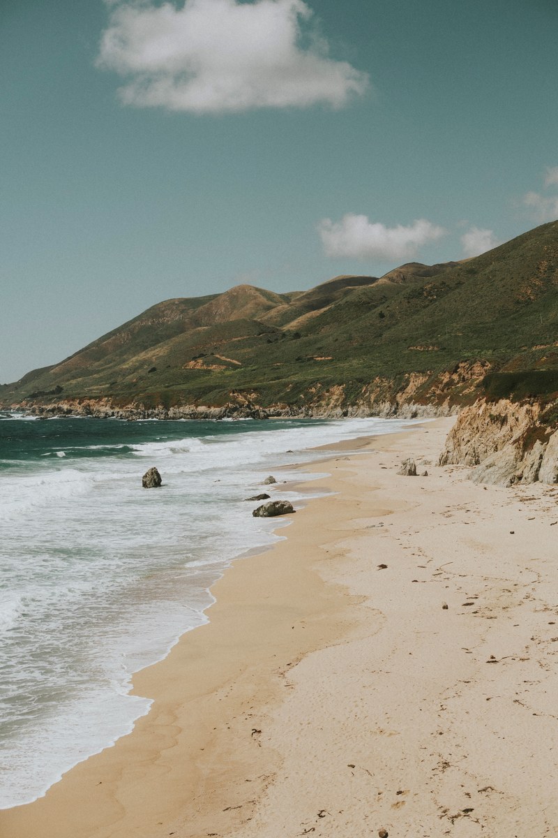 view of green hill shoreline from a sand beach, green hill shoreline view 4k