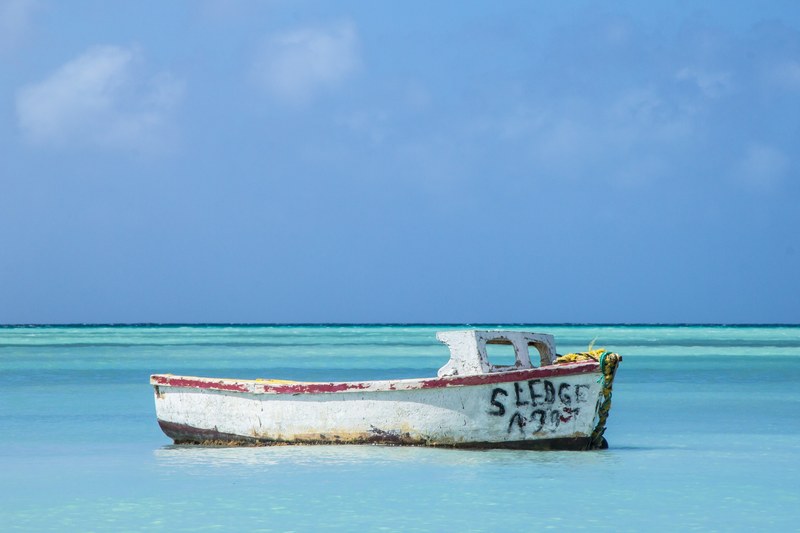 old white boat in the turquoise waters of palm beach, anchored boat 4k