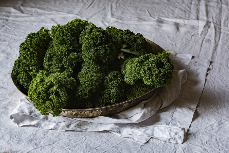 green kale on a platter on a white tablecloth, eat your vegetables 4k