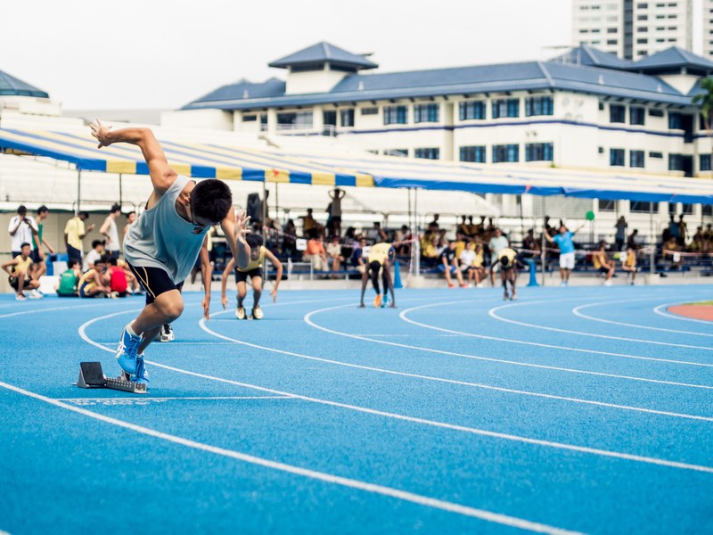 a race on the running track at anglo chinese school in singapore, chinese students sprinting 4k