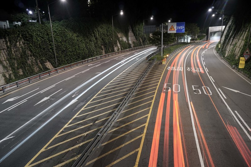 car headlights form red streaks speeding over a highway, speeding on the expressway 4k