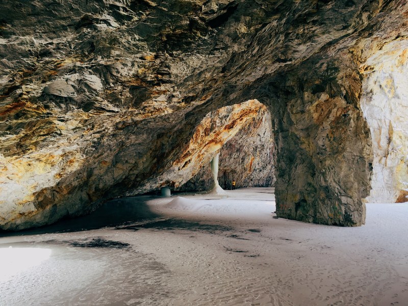 open rock cave on a sand beach, open rock cave 4k