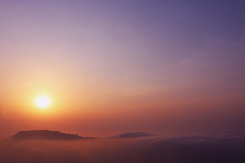 a gradient from orange to pink to purple and blue is created in the sky at sunset above the clouds, _sunrise 4k
