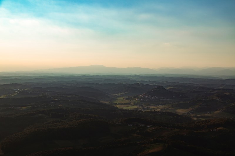 a vast rural landscape with hills crowning the horizon in riegersburg, hilly countryside in riegersburg 4k
