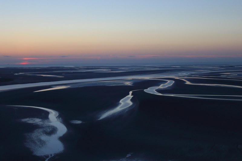 a hazy shot of the sea during the low tide at sunset, dry side 4k