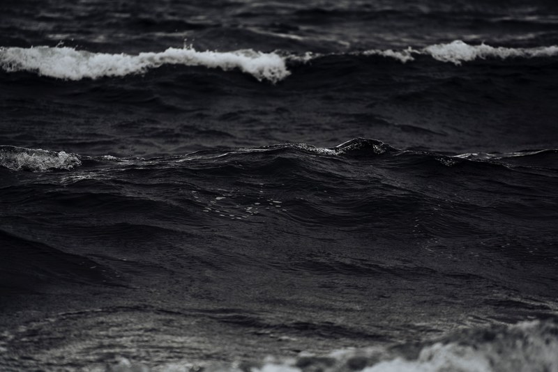 black and white shot of sea waves with ocean foam in iceland, monochrome icelandic waves 4k