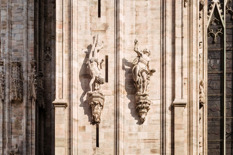 religious stone church architecture and statue sculptures of human figures at duomo di milano, stone building sculpture 4k