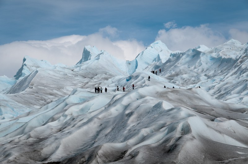 a group of trekkers climbing snow filled mountains with clear skies, _trekkers climb snow filled mountains 4k
