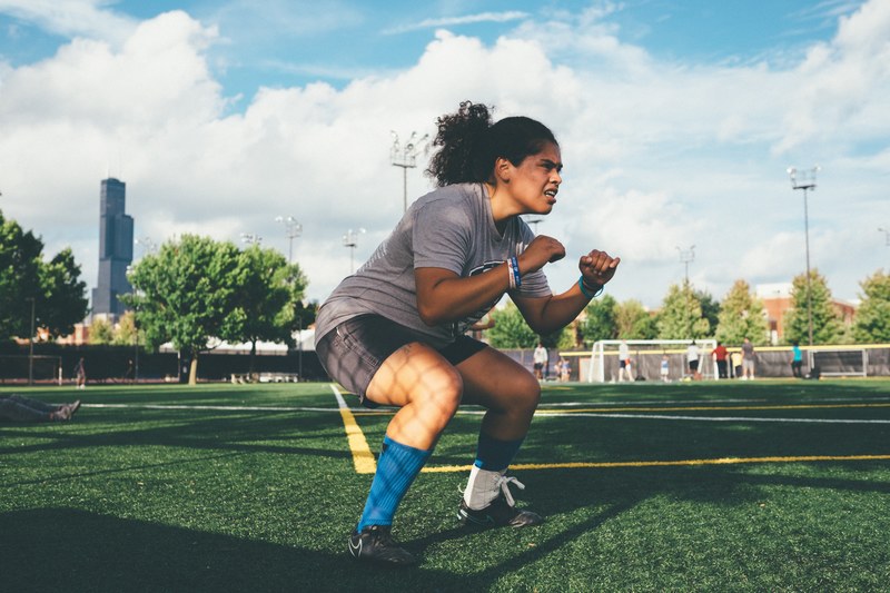 athletic woman in position to during soccer practice on a field, soccer player 4k
