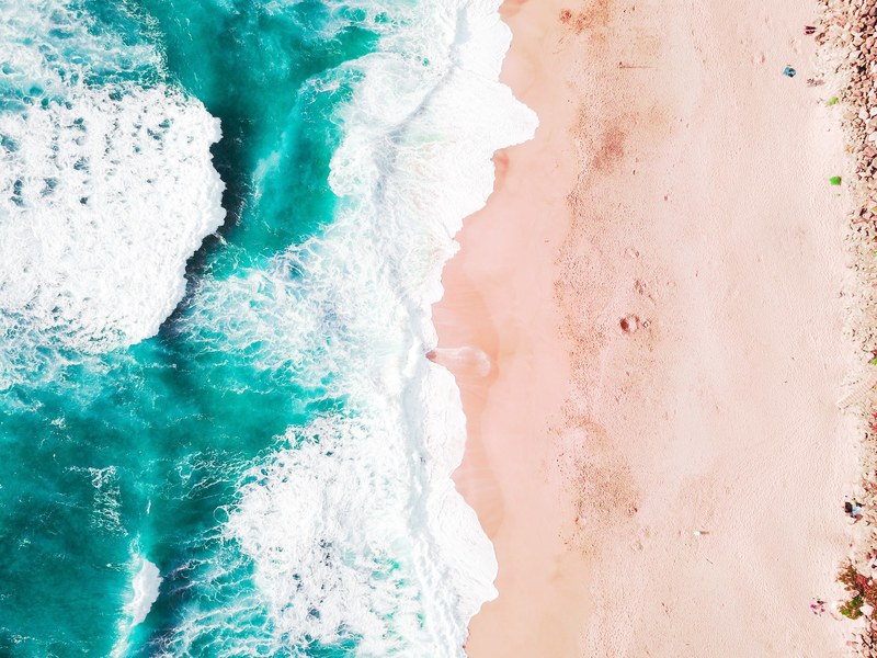 drone aerial view of the ocean washing on the sand beach in california, california 4k
