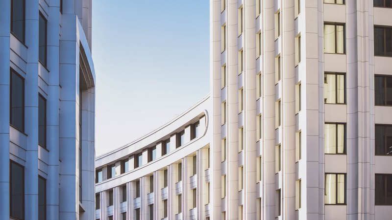 long white building facades with concrete ribbing, white ribs on a long facade 4k