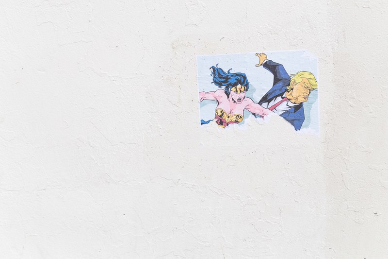 wonder woman punching donald trump street art on white wall in center street, wonder woman punches trump 4k