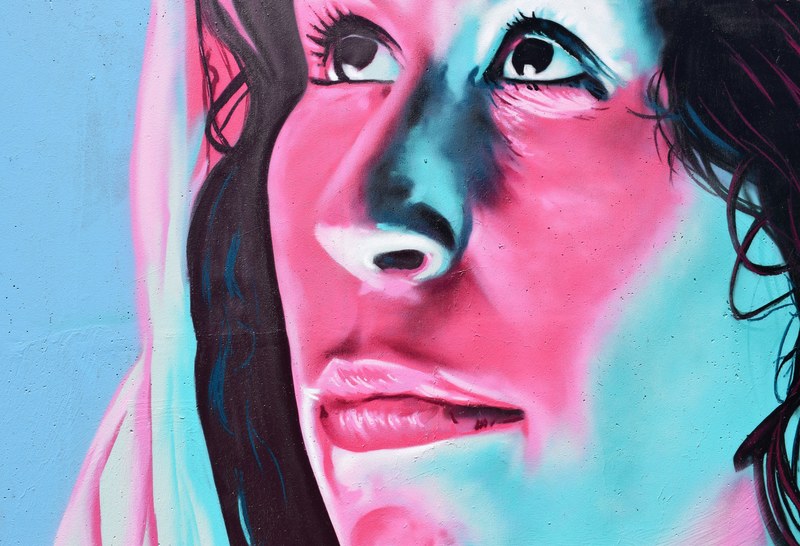 a mural of a womans face in pink blue and black, mural of a woman 4k
