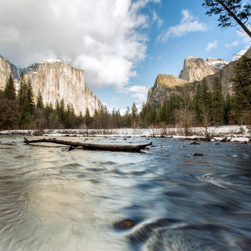 a river flowing through a mountain valley with a tree trunk in the middle, el cap 4k
