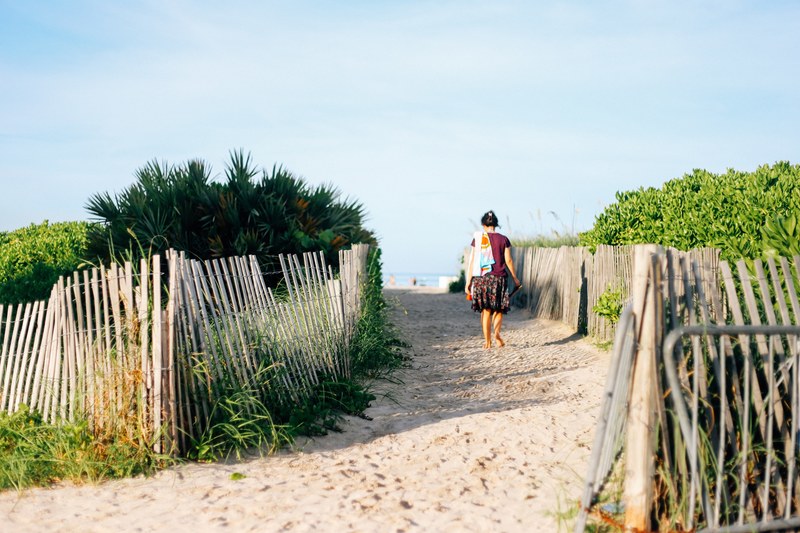 beach sand woman and picket fence 4k