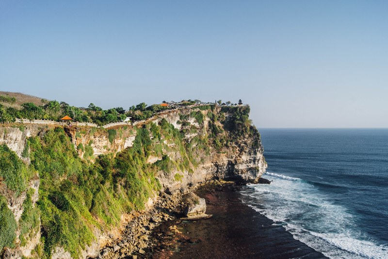 scenic beach on a cliff features natures finest rocks trees and foliage with sea underneath, scenic beach off a cliff 4k