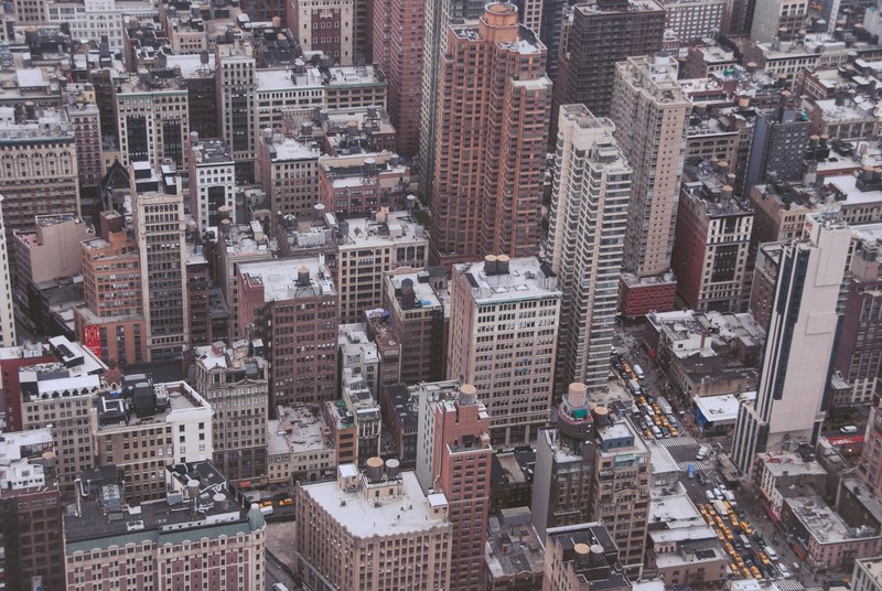 a high shot of city streets with high rises and residential buildings, city wake up 4k