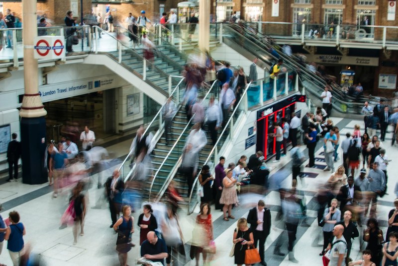 a long exposure shot of a busy london underground station, london underground atrium 4k
