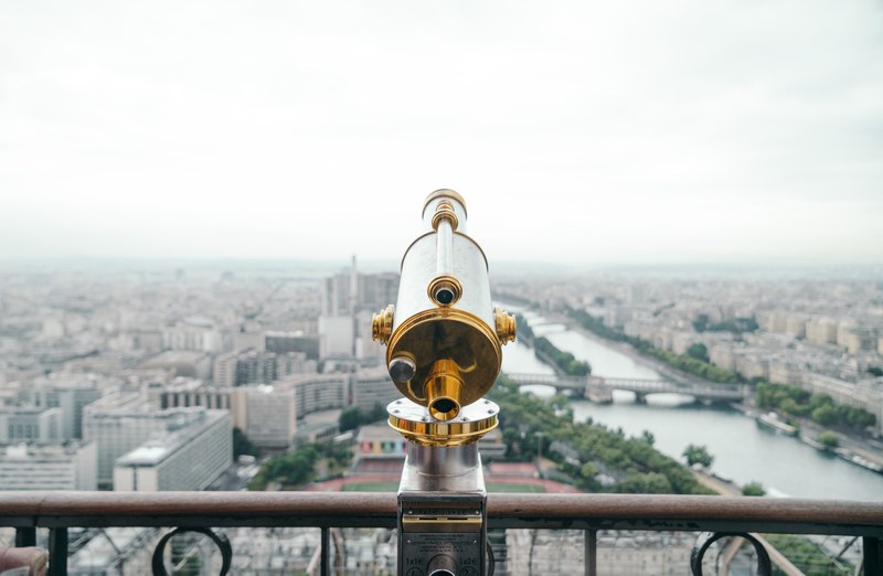 a telescope in front of a rail overlooking paris and the seine river, telescope overlooking paris 4k