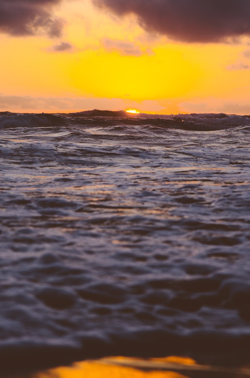 an orange sky at sunset over the waves of the ocean at venus bay, wave after wave 4k