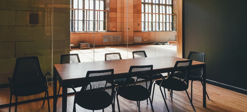 an empty table with several chairs in a small conference room, small conference room 4k