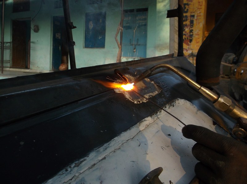 a person welding metal in a workshop, welder at work 4k