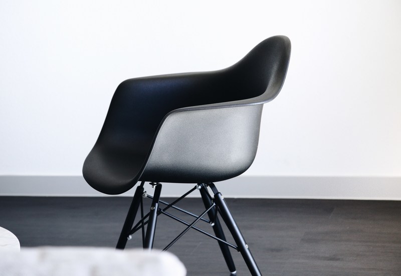 a small black plastic chair, black eames style chair 4k