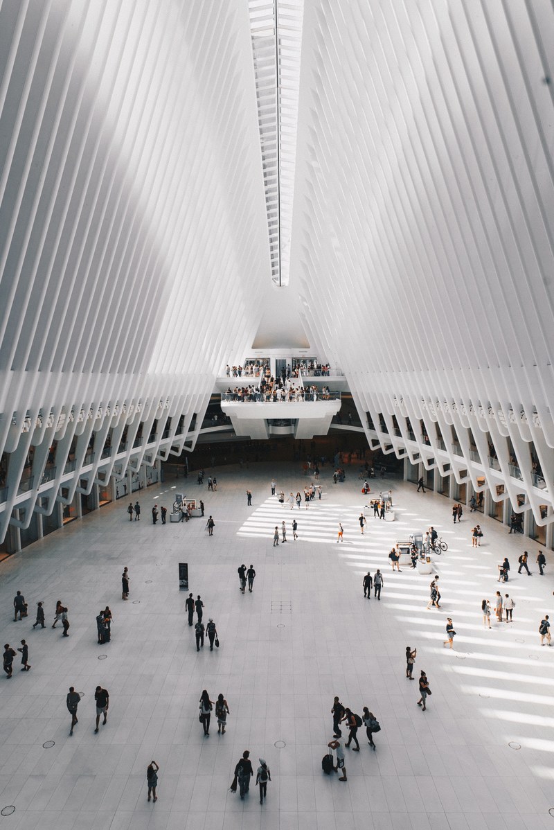 the interior of a large transport hub with a tall white ribbed ceiling, the o part iii 4k