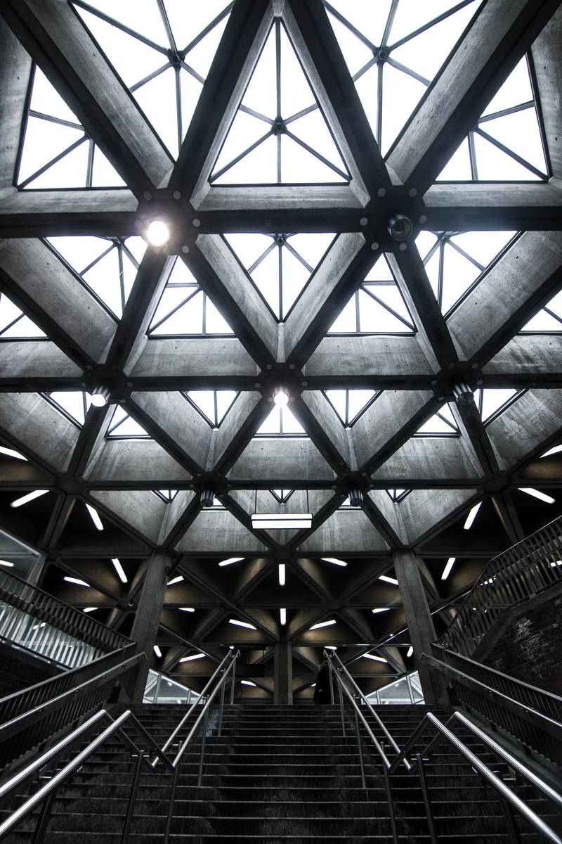light fixtures on a meshwork of concrete ceiling support beams, concrete support beams 4k